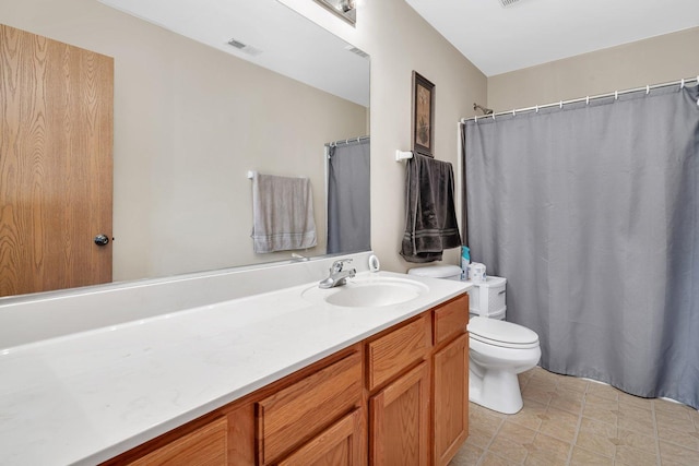 bathroom featuring visible vents, vanity, and toilet