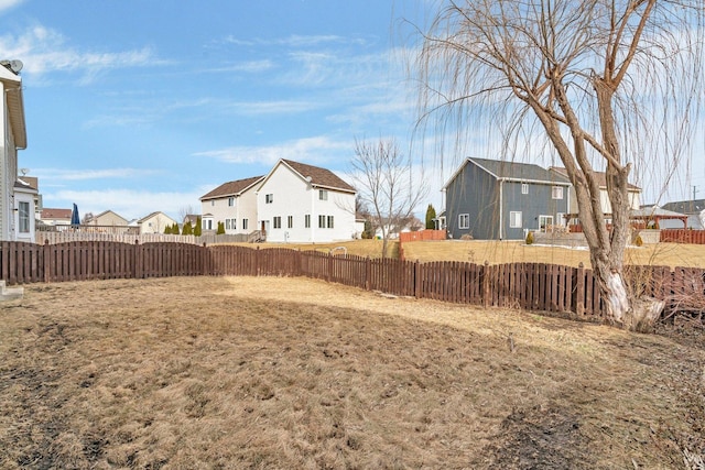 view of yard featuring a residential view and a fenced backyard