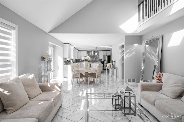 living room with marble finish floor, high vaulted ceiling, visible vents, and recessed lighting