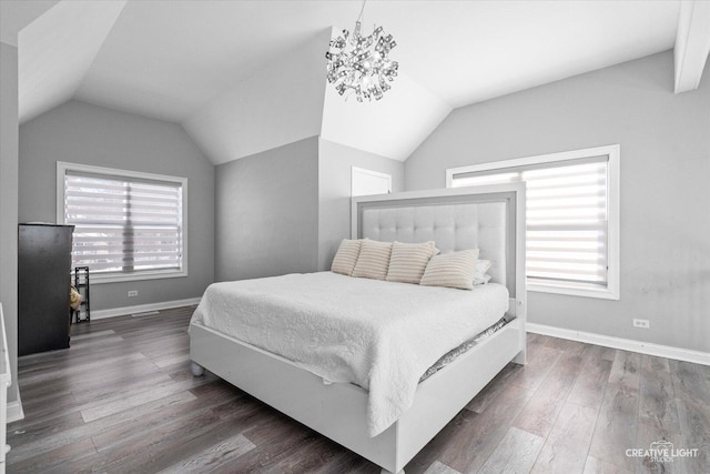 bedroom with multiple windows, vaulted ceiling, and dark wood-type flooring