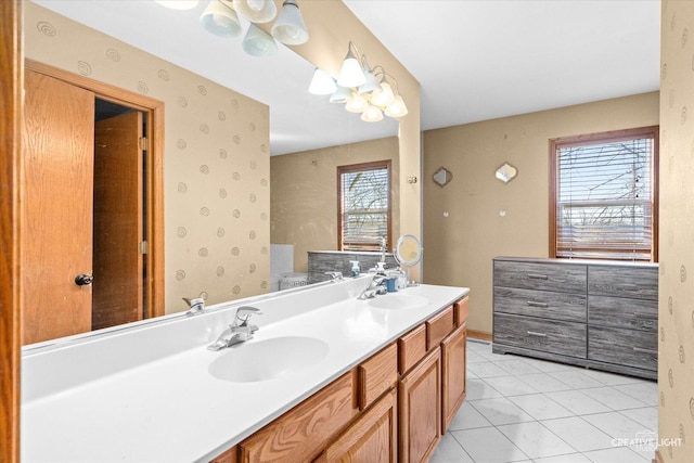 bathroom with double vanity, tile patterned flooring, a sink, and wallpapered walls