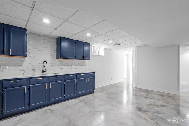 kitchen with blue cabinets, light countertops, and a sink