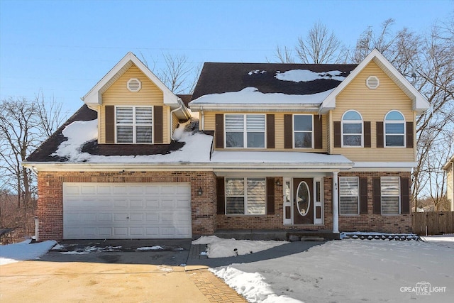 traditional home featuring a garage, concrete driveway, and brick siding