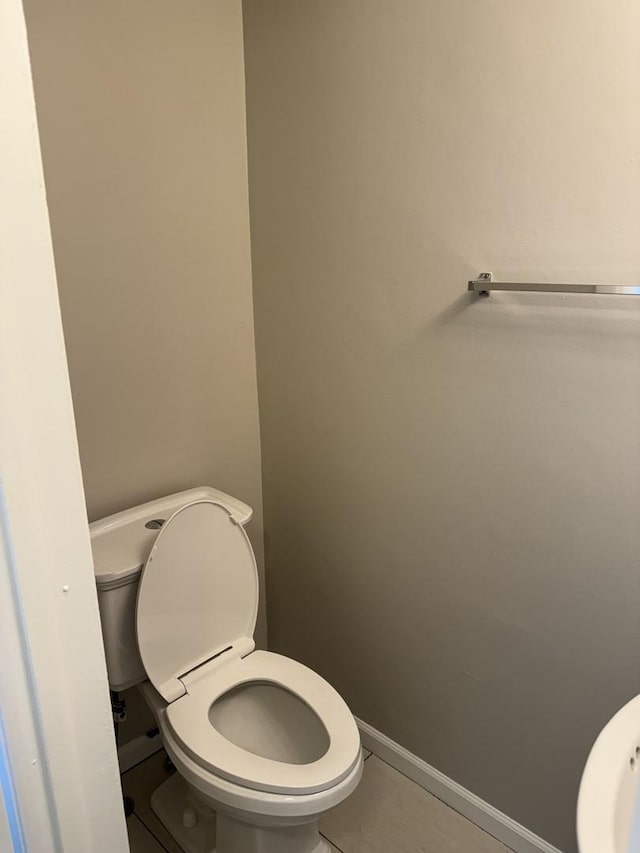 bathroom with toilet and baseboards