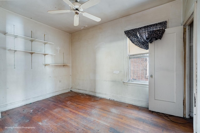 empty room featuring hardwood / wood-style flooring and a ceiling fan