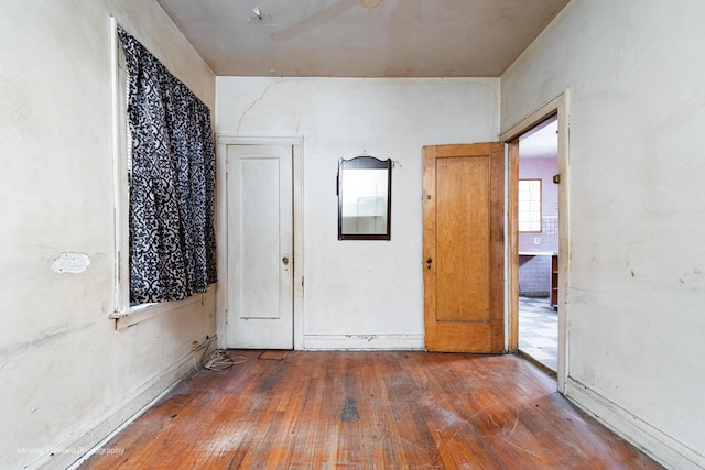 unfurnished room with hardwood / wood-style floors