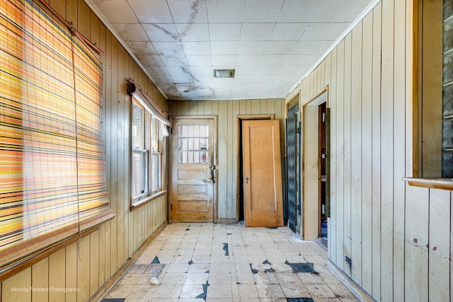 interior space with light floors and wood walls