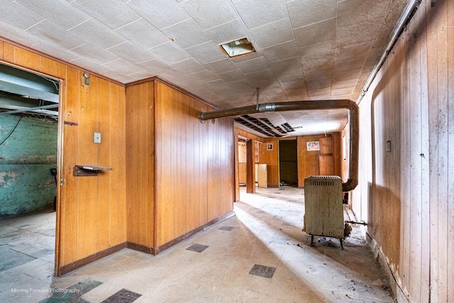 hallway featuring wood walls