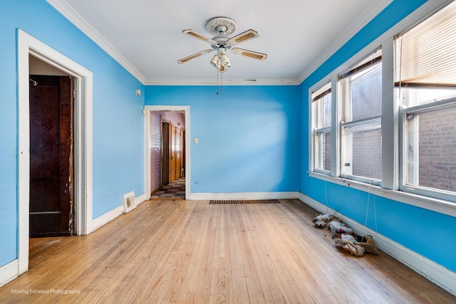 unfurnished room with baseboards, ceiling fan, light wood-style flooring, and crown molding