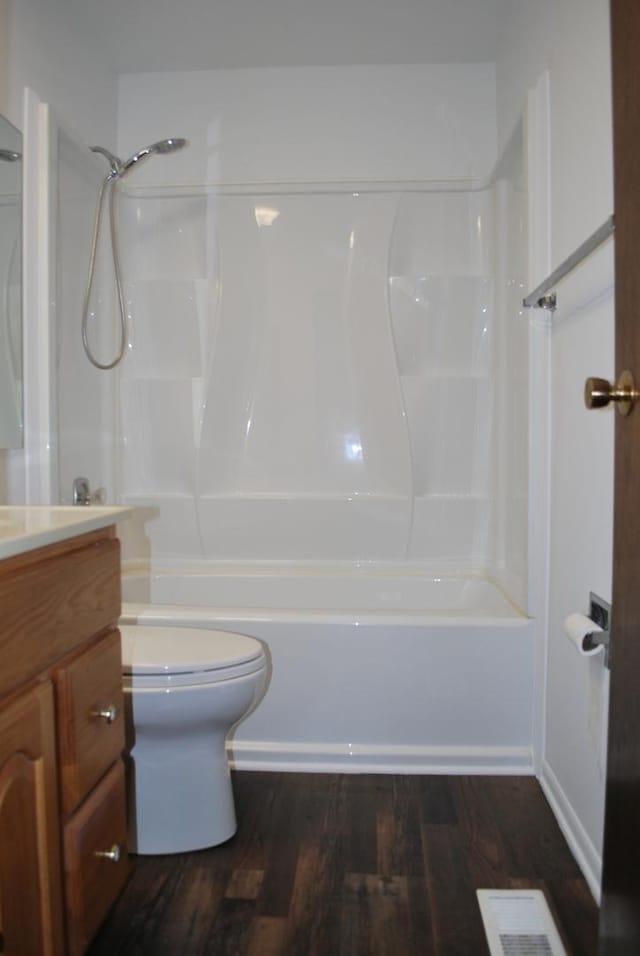 bathroom featuring visible vents, shower / bathing tub combination, vanity, and wood finished floors