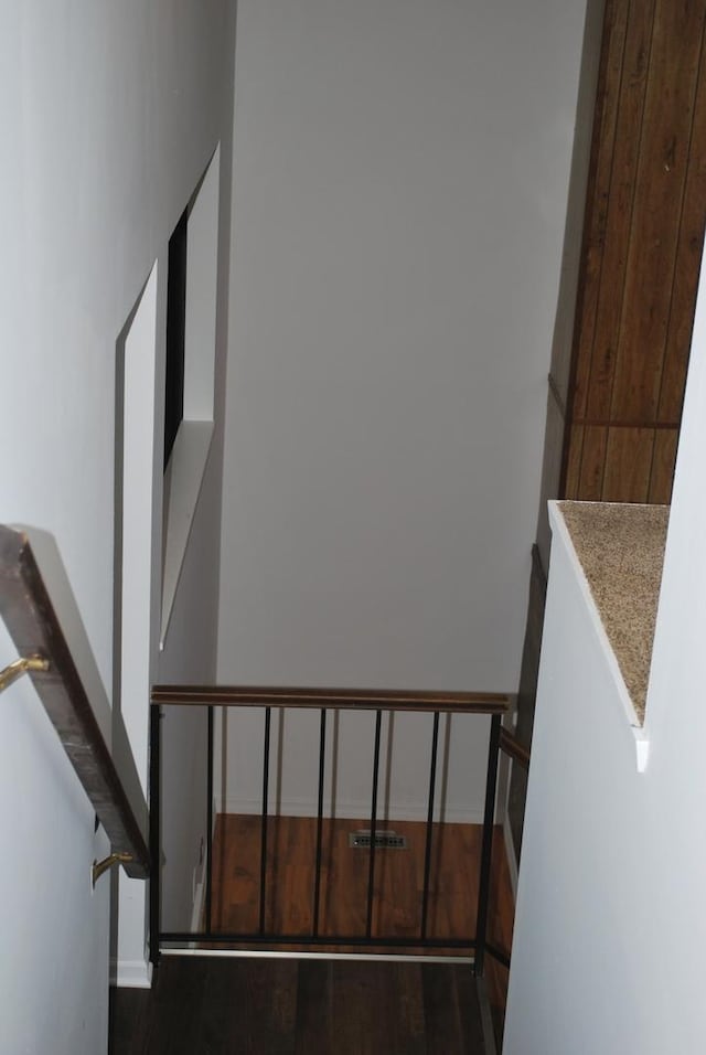 staircase with wood finished floors