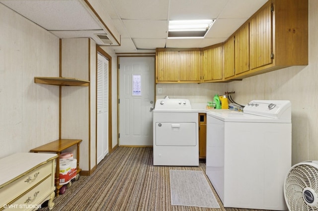 laundry room featuring visible vents, cabinet space, carpet flooring, and washer and clothes dryer