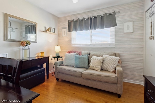 living area featuring baseboards and wood finished floors