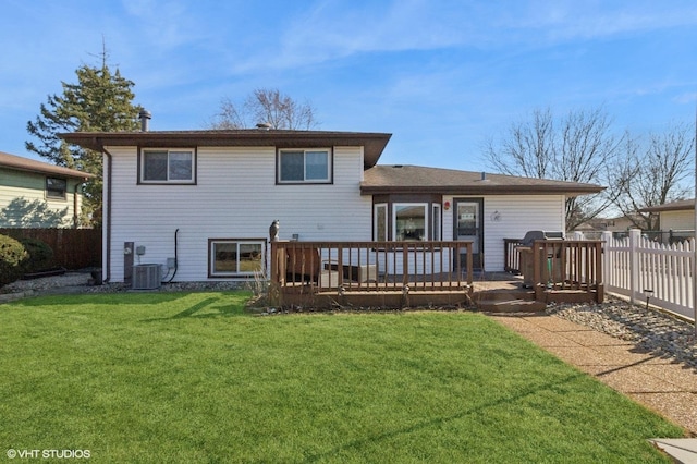 back of property featuring a yard, fence, and a wooden deck