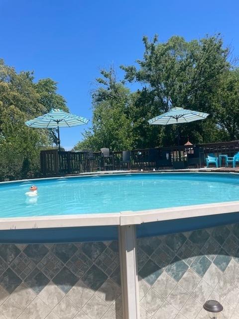 view of swimming pool featuring a fenced in pool and fence