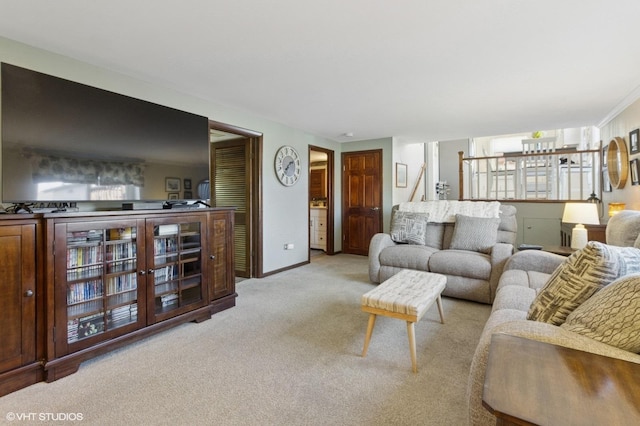 living room featuring baseboards and light colored carpet