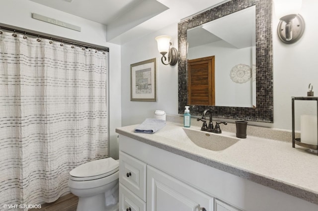 full bath featuring vanity, toilet, and wood finished floors