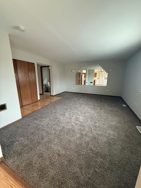 unfurnished living room featuring carpet flooring