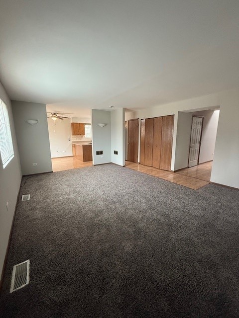 unfurnished bedroom featuring light colored carpet and visible vents