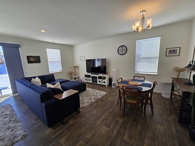 living room featuring dark wood-style floors, a chandelier, and baseboards