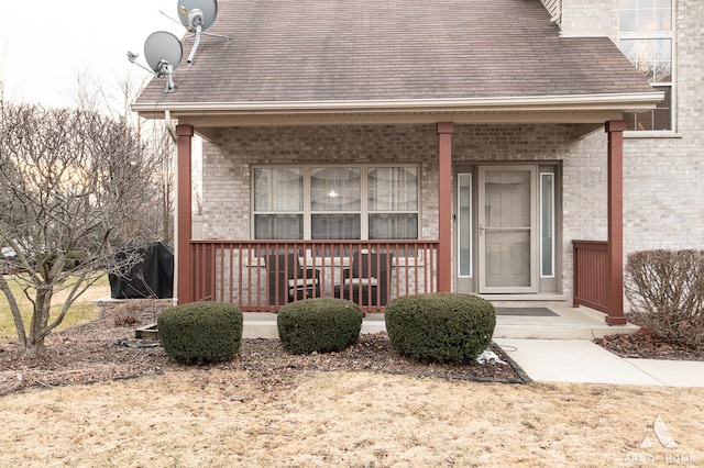 exterior space with covered porch and brick siding