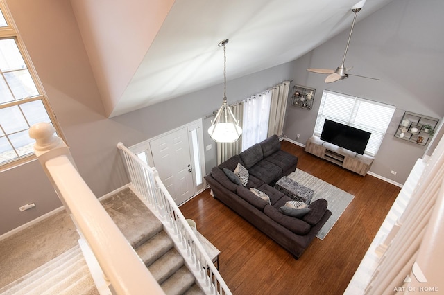 living area with high vaulted ceiling, dark wood-style flooring, a fireplace, and baseboards