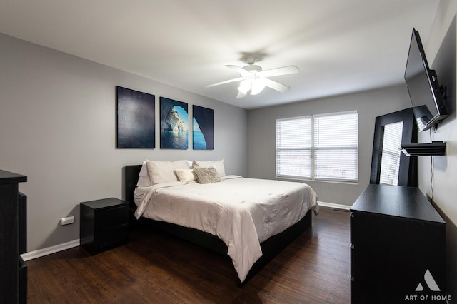 bedroom with dark wood-style floors, baseboards, and a ceiling fan