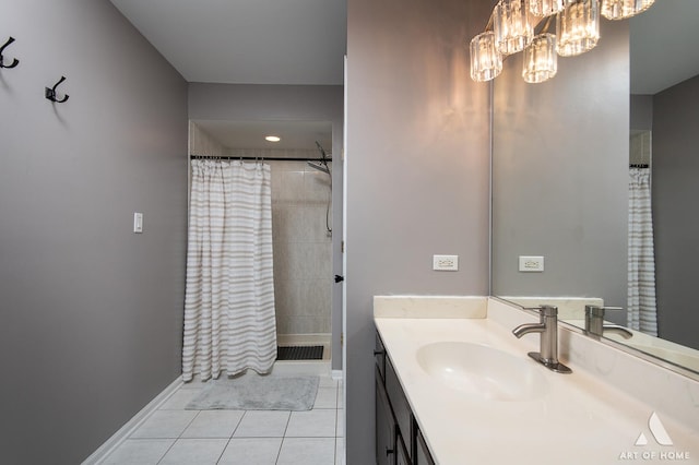 full bathroom featuring a chandelier, visible vents, vanity, a tile shower, and tile patterned floors