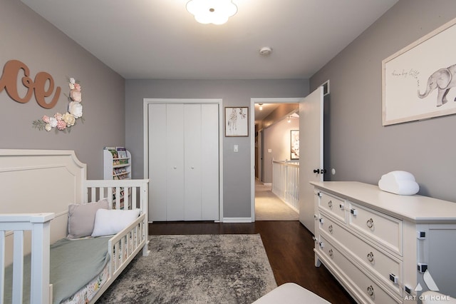 bedroom featuring dark wood-type flooring and a closet