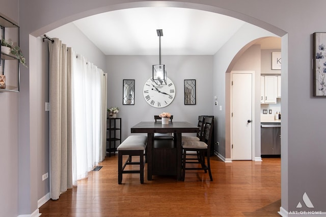 dining space featuring baseboards and wood finished floors