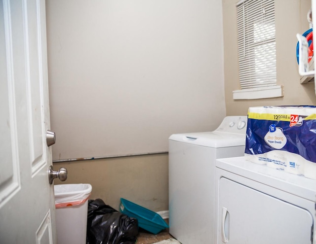 clothes washing area featuring laundry area and washing machine and clothes dryer