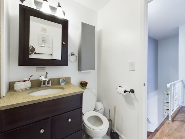 half bathroom with toilet and vanity