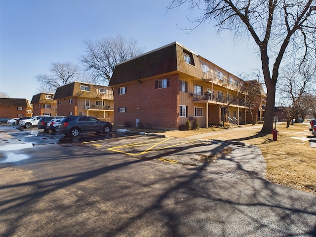 view of property with uncovered parking