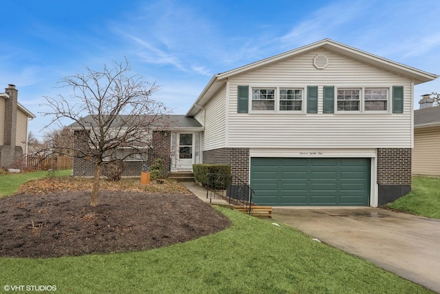 split level home with driveway, a front yard, a garage, and brick siding