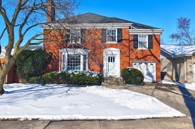 view of front of house featuring brick siding, driveway, and an attached garage