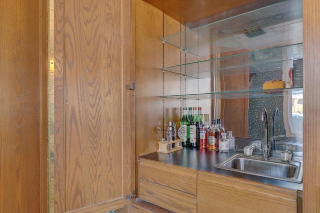 bar featuring indoor wet bar and a sink