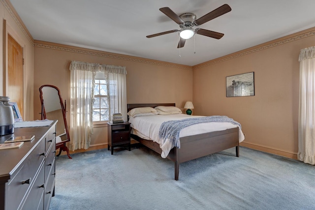 bedroom featuring light carpet, baseboards, a ceiling fan, and crown molding