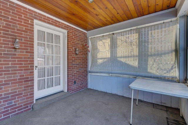 unfurnished sunroom with a wealth of natural light and wooden ceiling