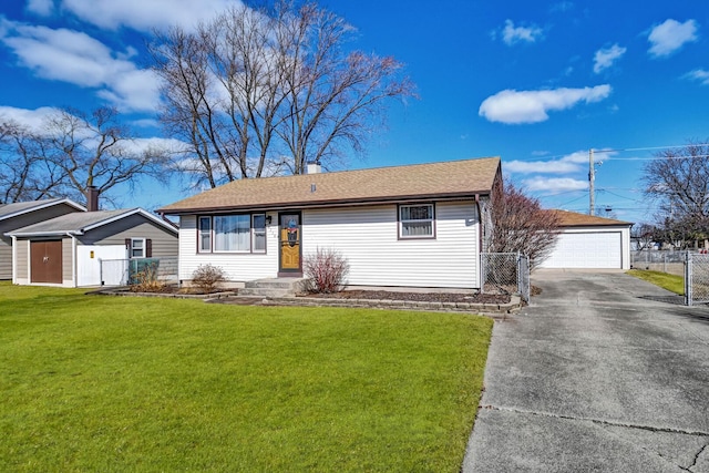 ranch-style home with a front yard, an outdoor structure, a detached garage, and fence