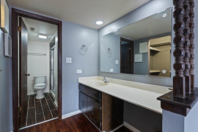 full bathroom with baseboards, visible vents, wood finished floors, vanity, and a shower stall