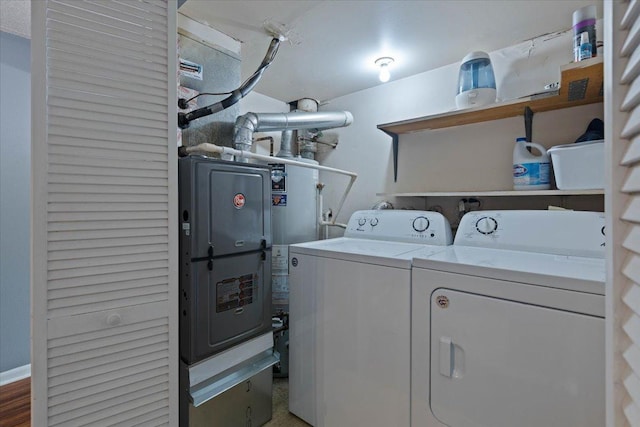 clothes washing area with separate washer and dryer