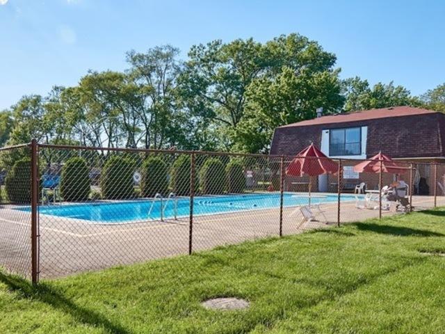 pool featuring fence and a lawn