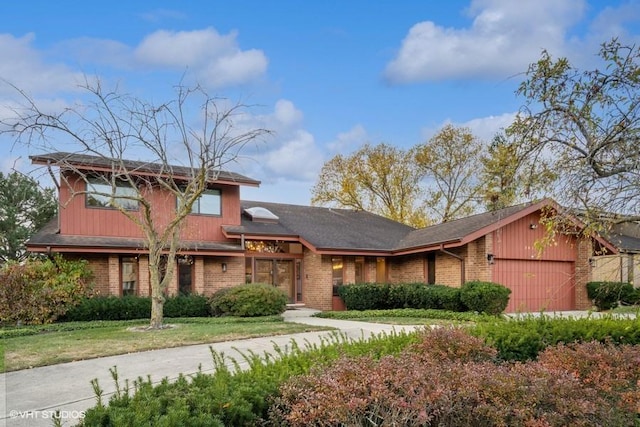 view of front facade featuring a garage and brick siding