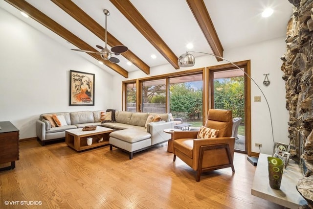 living room with vaulted ceiling with beams, light wood-type flooring, a ceiling fan, and baseboards