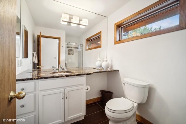 full bath with a stall shower, baseboards, toilet, tile patterned flooring, and vanity