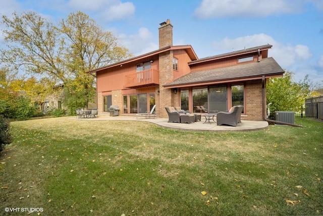 back of property featuring cooling unit, a lawn, a balcony, and a patio