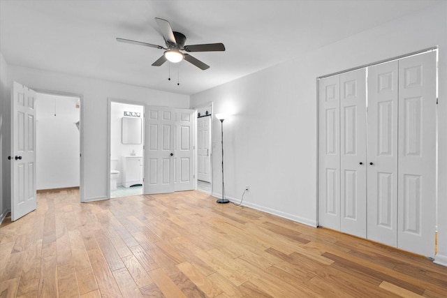 unfurnished bedroom featuring light wood-style floors, connected bathroom, baseboards, and a ceiling fan