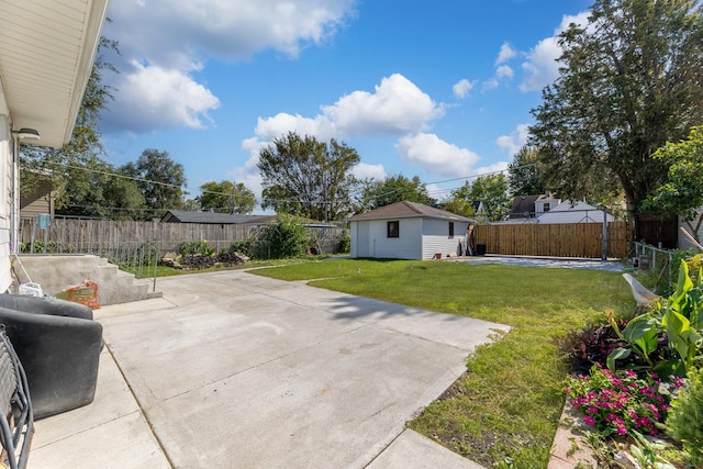 view of yard featuring an outbuilding, a fenced backyard, and a patio