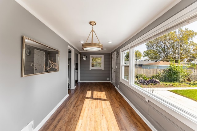 interior space with dark wood finished floors and baseboards