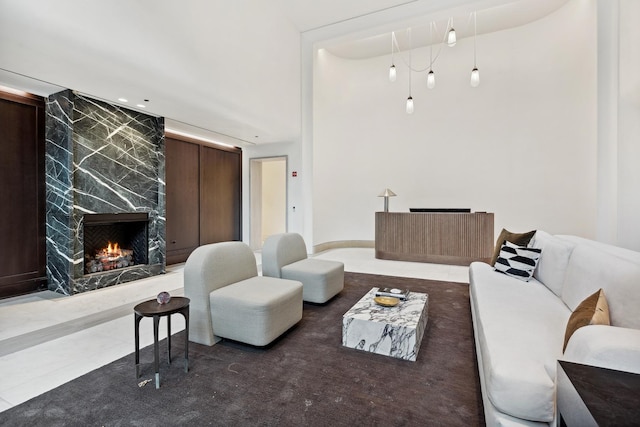 tiled living room featuring a high end fireplace